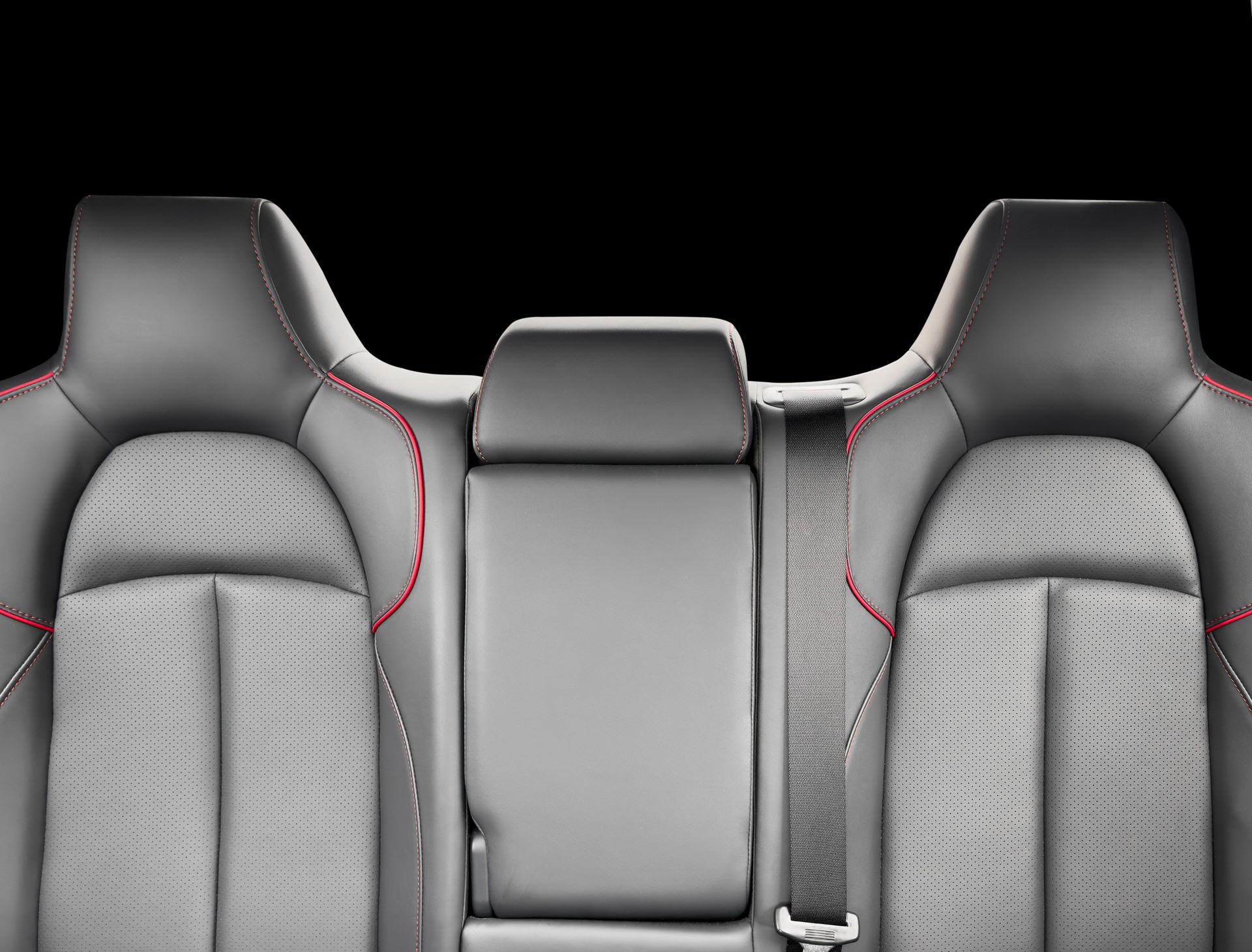 Back passenger black seats in modern luxury car. Black perforated leather with white stitching. Car details. Leather comfortable seats. Car interior details